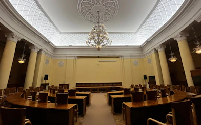 Interior of a conference room with chandeliers and columns at the Palace of Culture and Science in Warsaw.