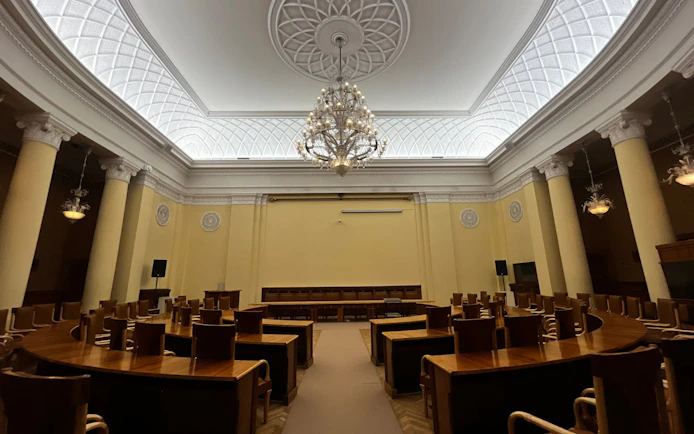 Interior of a conference room with chandeliers and columns at the Palace of Culture and Science in Warsaw.