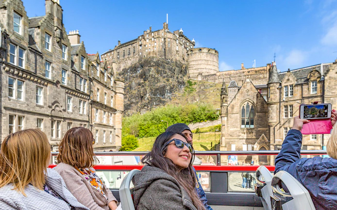 Tourists on a hop-on hop-off bus viewing Edinburgh Castle during the Royal Edinburgh Tour.