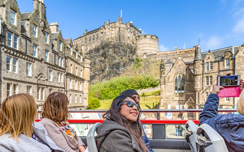 Tourists on a hop-on hop-off bus viewing Edinburgh Castle during the Royal Edinburgh Tour.