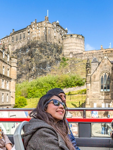 Tourists on a hop-on hop-off bus viewing Edinburgh Castle during the Royal Edinburgh Tour.