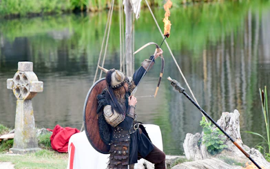 Viking reenactor with flaming arrow at Puy du Fou, France.