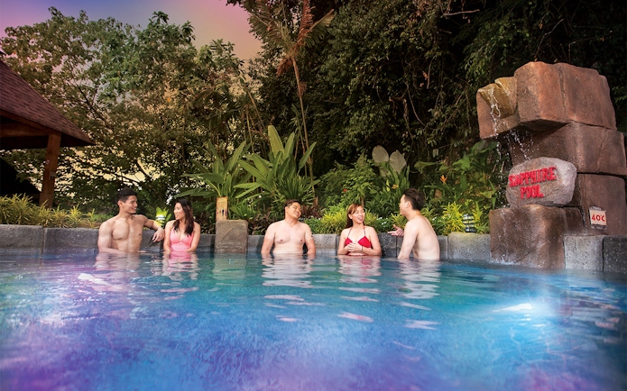 Visitors enjoying the Sapphire Pool at Lost World Hot Springs Night Park.