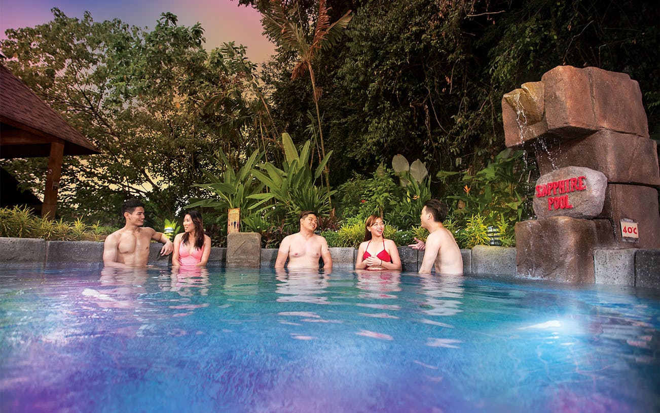 Visitors enjoying the Sapphire Pool at Lost World Hot Springs Night Park.