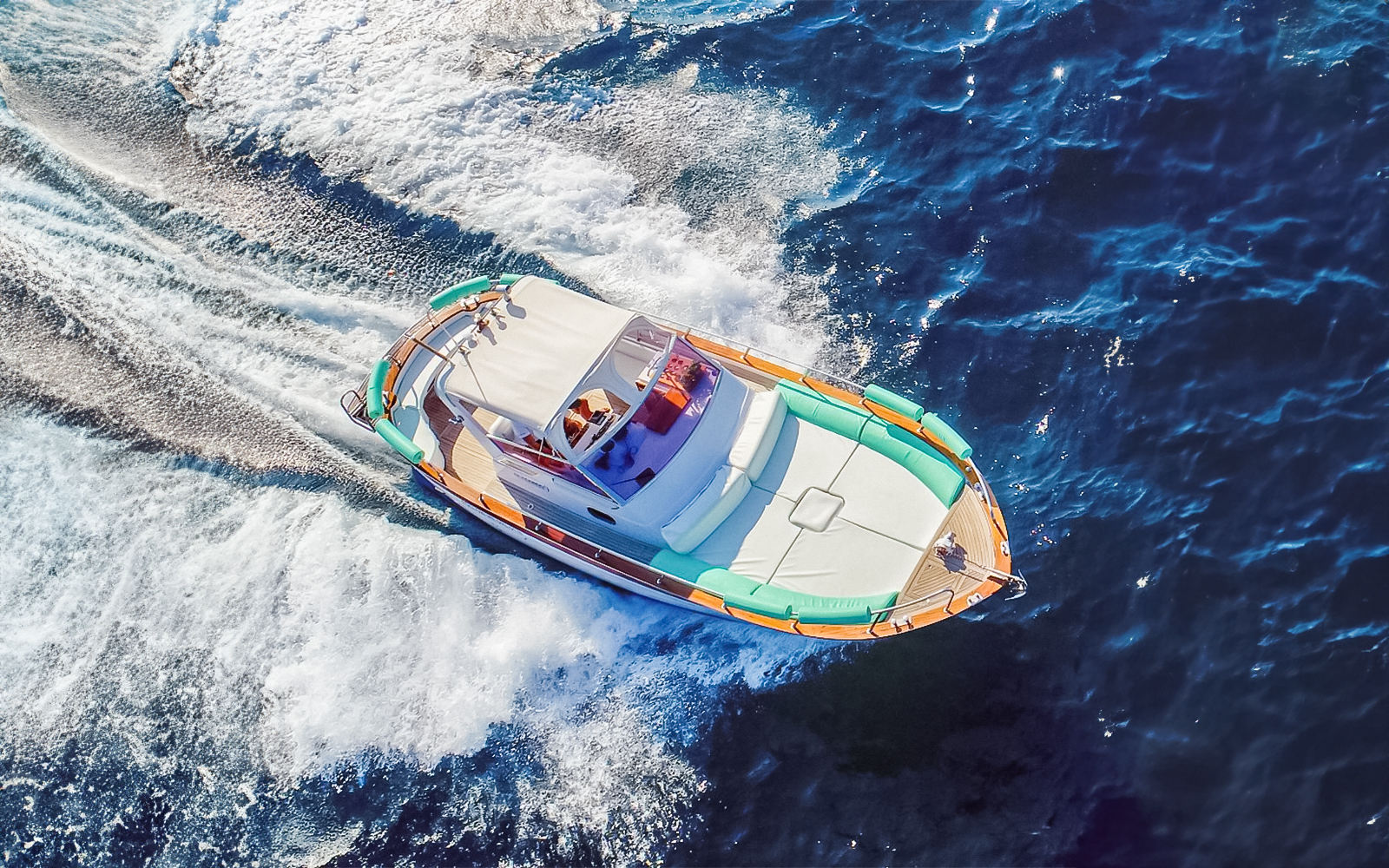 Boat cruising on blue waters during all-inclusive Capri tour from Pompeii or Naples.