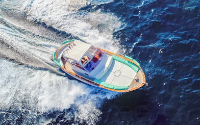 Boat cruising on blue waters during all-inclusive Capri tour from Pompeii or Naples.
