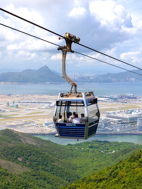 Cable car over Lantau Island with view of Hong Kong International Airport.