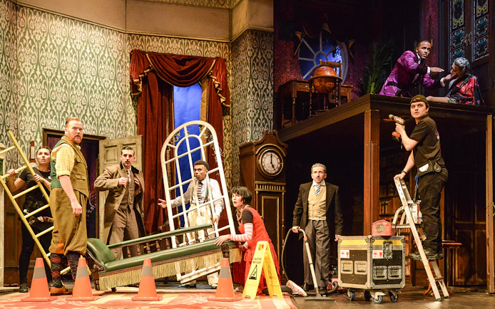 Cast members on stage during a chaotic scene from "The Play That Goes Wrong.