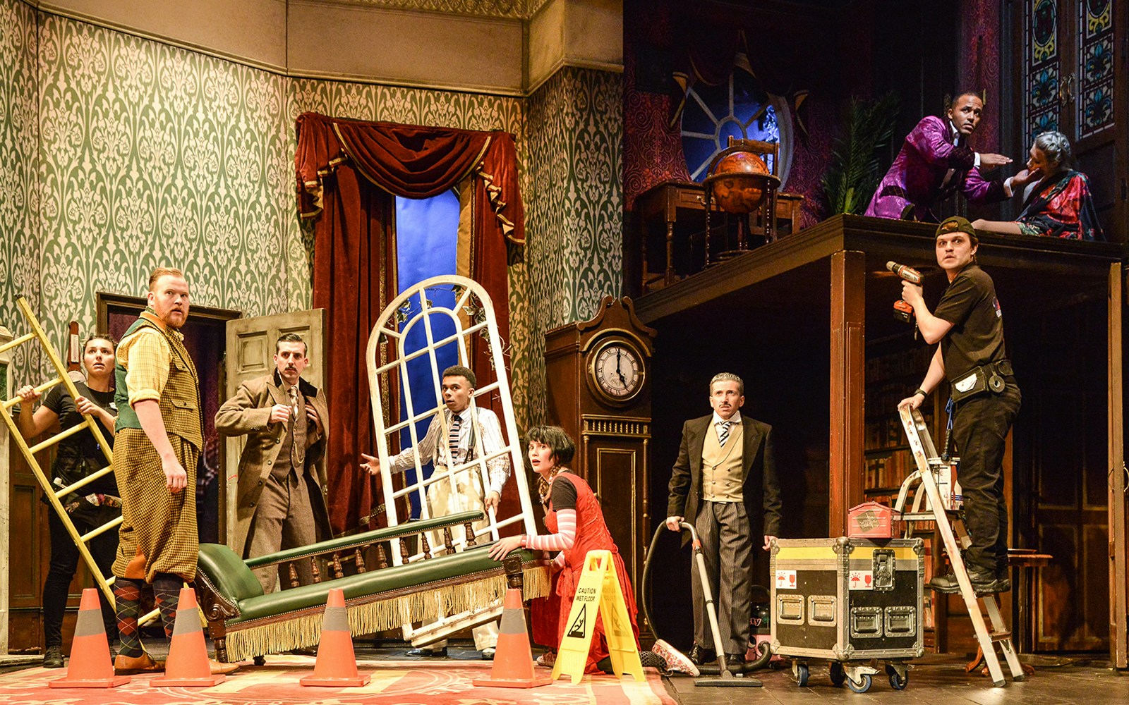 Cast members on stage during a chaotic scene from "The Play That Goes Wrong.