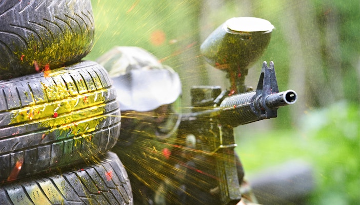 Group of people playing paintball in a forested area in Barcelona, Spain.