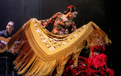 Flamenco dancer performing with shawl at Teatro Flamenco Madrid.