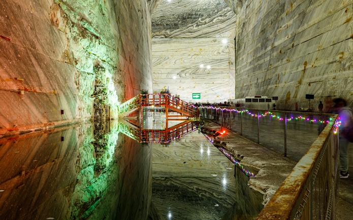 Slanic Prahova Salt Mine interior with illuminated bridge and reflective water, near Bucharest.