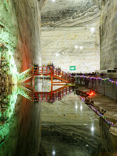 Slanic Prahova Salt Mine interior with illuminated bridge and reflective water, near Bucharest.