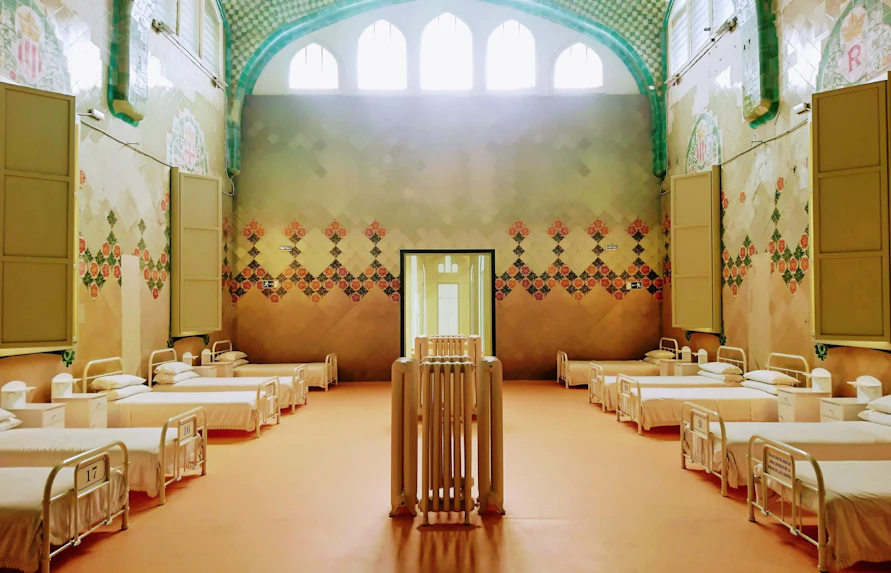 Sant Rafael Pavilion ward with ornate tiles and rows of beds at Recinte Modernista de Sant Pau.