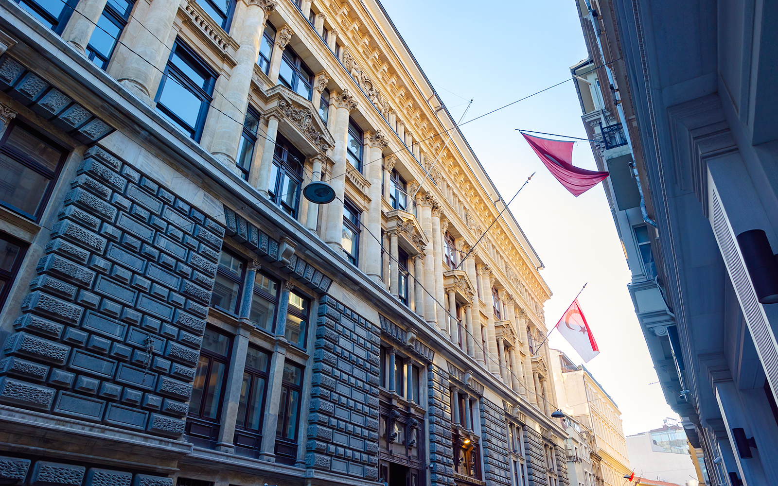 Historic building facade of Salt Museum in Istanbul with flags and architectural details.