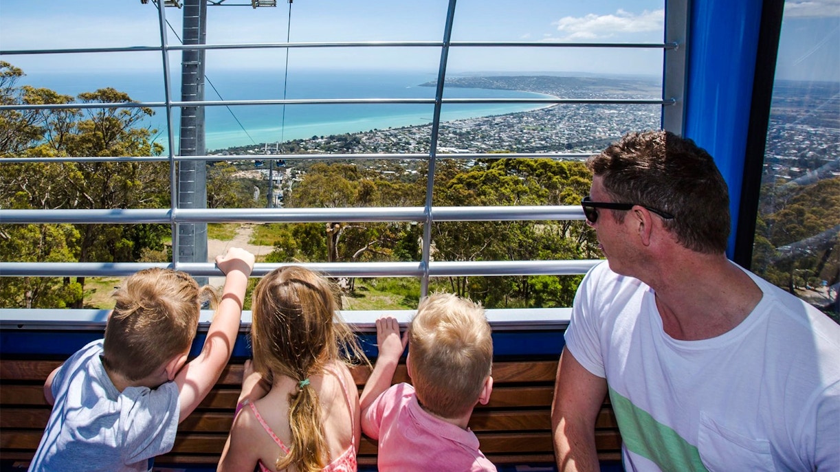 Family enjoying the view from Arthurs Seat Eagle Gondola, overlooking the coastline.