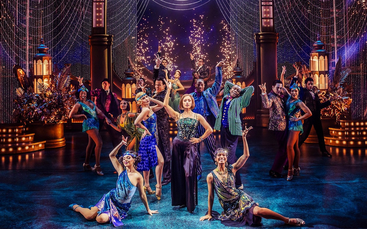 Stage performance of The Great Gatsby in New York with dancers in 1920s attire.