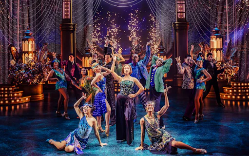 Stage performance of The Great Gatsby in New York with dancers in 1920s attire.