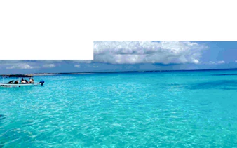 Boat on turquoise waters during Zanzibar Blue Safari snorkeling tour.