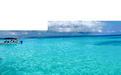 Boat on turquoise waters during Zanzibar Blue Safari snorkeling tour.