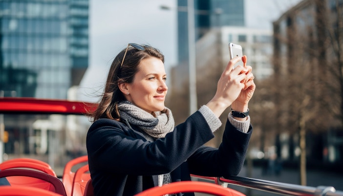 woman taking pictures during hoho tour
