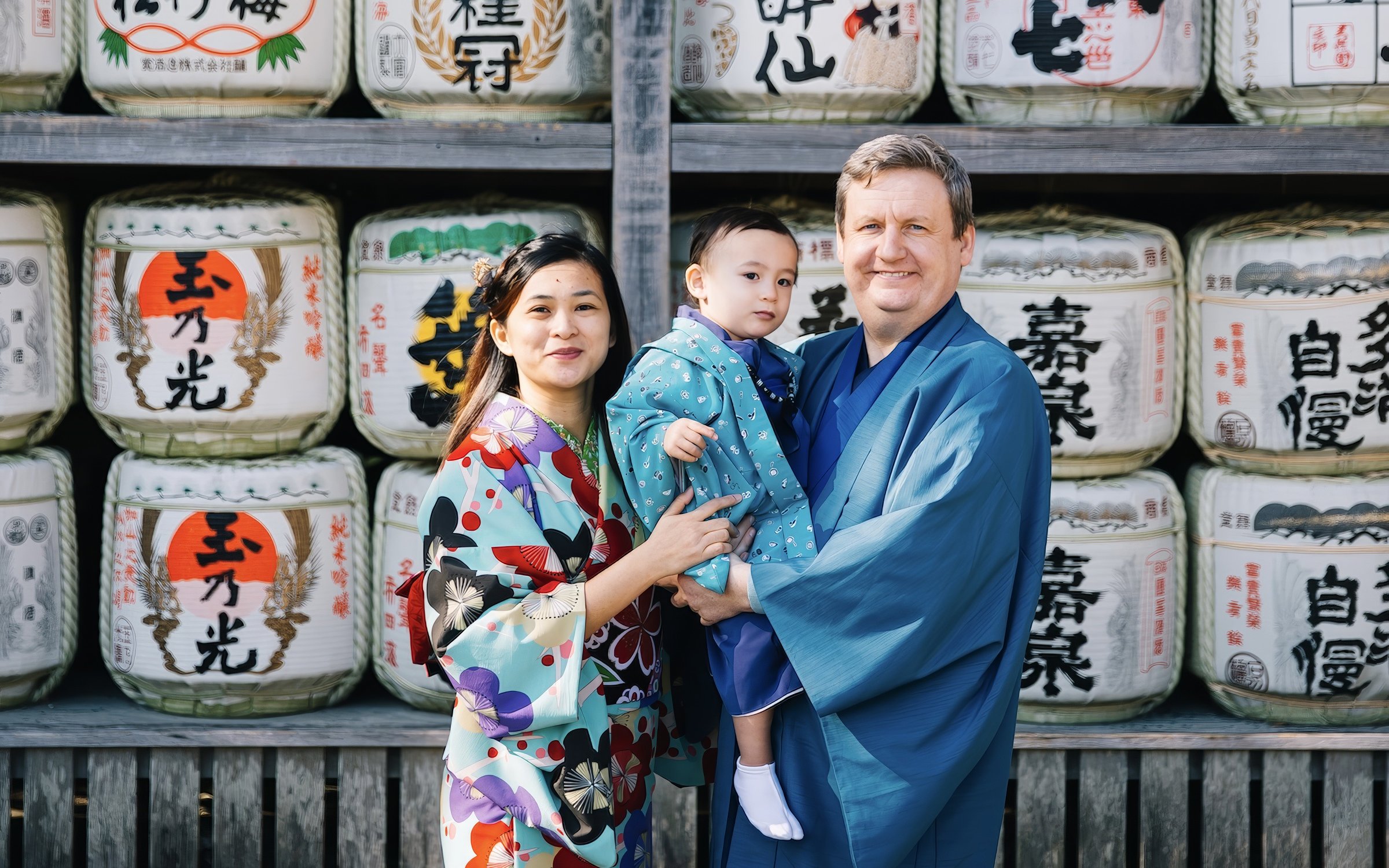 Family in traditional Japanese attire at a sake brewery with sake barrels in the background.