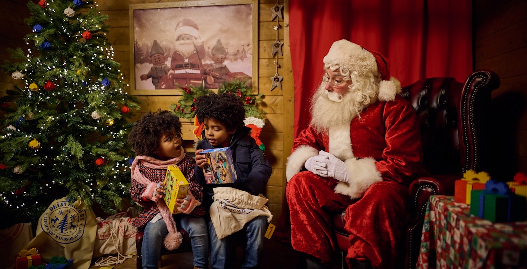Children receiving gifts from Santa at Legoland Windsor during Christmas.