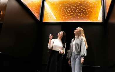 Visitors admiring illuminated art installation inside Tokyo Skytree.
