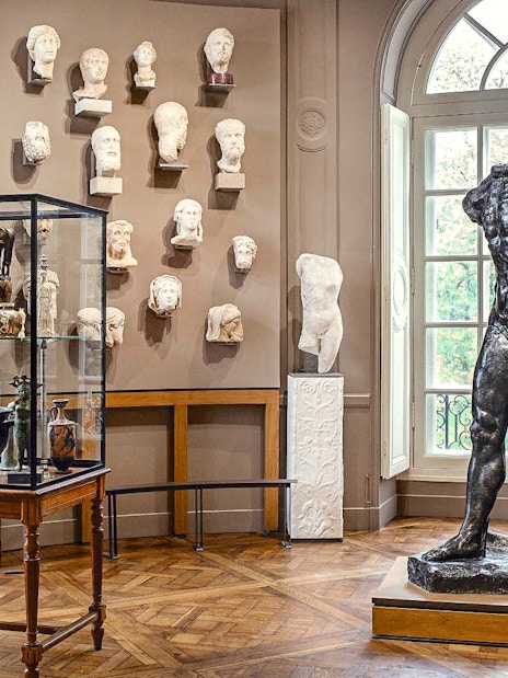 Rodin Museum interior with sculptures and artifacts display in Paris.