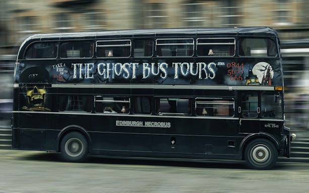 Edinburgh double-decker bus for Ghost Bus Tour with spooky artwork.