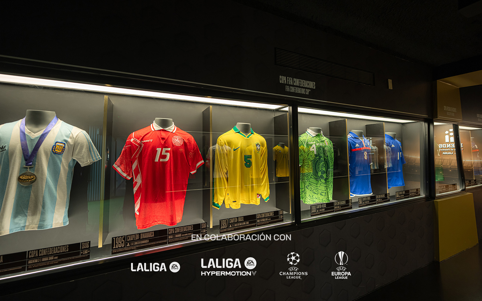 Football jerseys displayed in a museum exhibit featuring international teams.