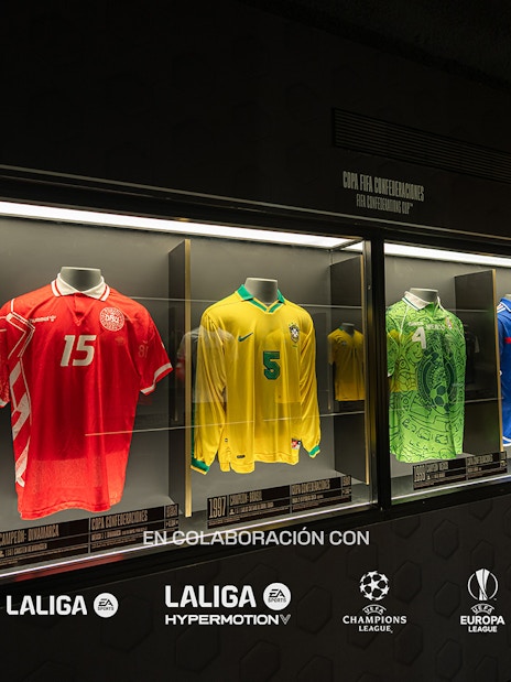 Football jerseys displayed in a museum exhibit featuring international teams.