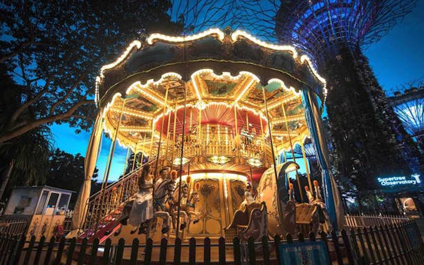 Carousel at Christmas Wonderland 2022, Gardens By The Bay, Singapore, with Supertree Grove in background.