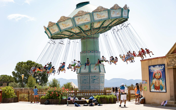 Visitors enjoying a swing ride at Terra Mitica theme park in Spain.