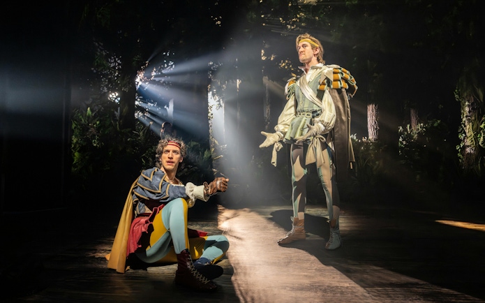 Actors performing in a forest scene from "Into The Woods" production.