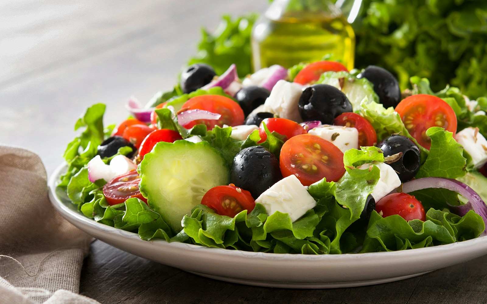 salad with tomatoes, cucumbers, olives, and tofu