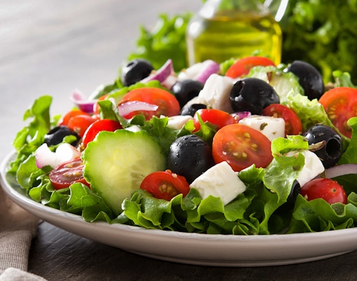 Greek salad with tomatoes, cucumbers, olives, and feta on Athens Original Vegan Tour.