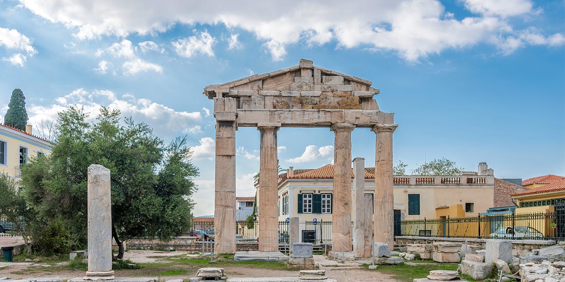 Propylaea entrance at Acropolis, Athens, with tourists exploring the ancient gateway.