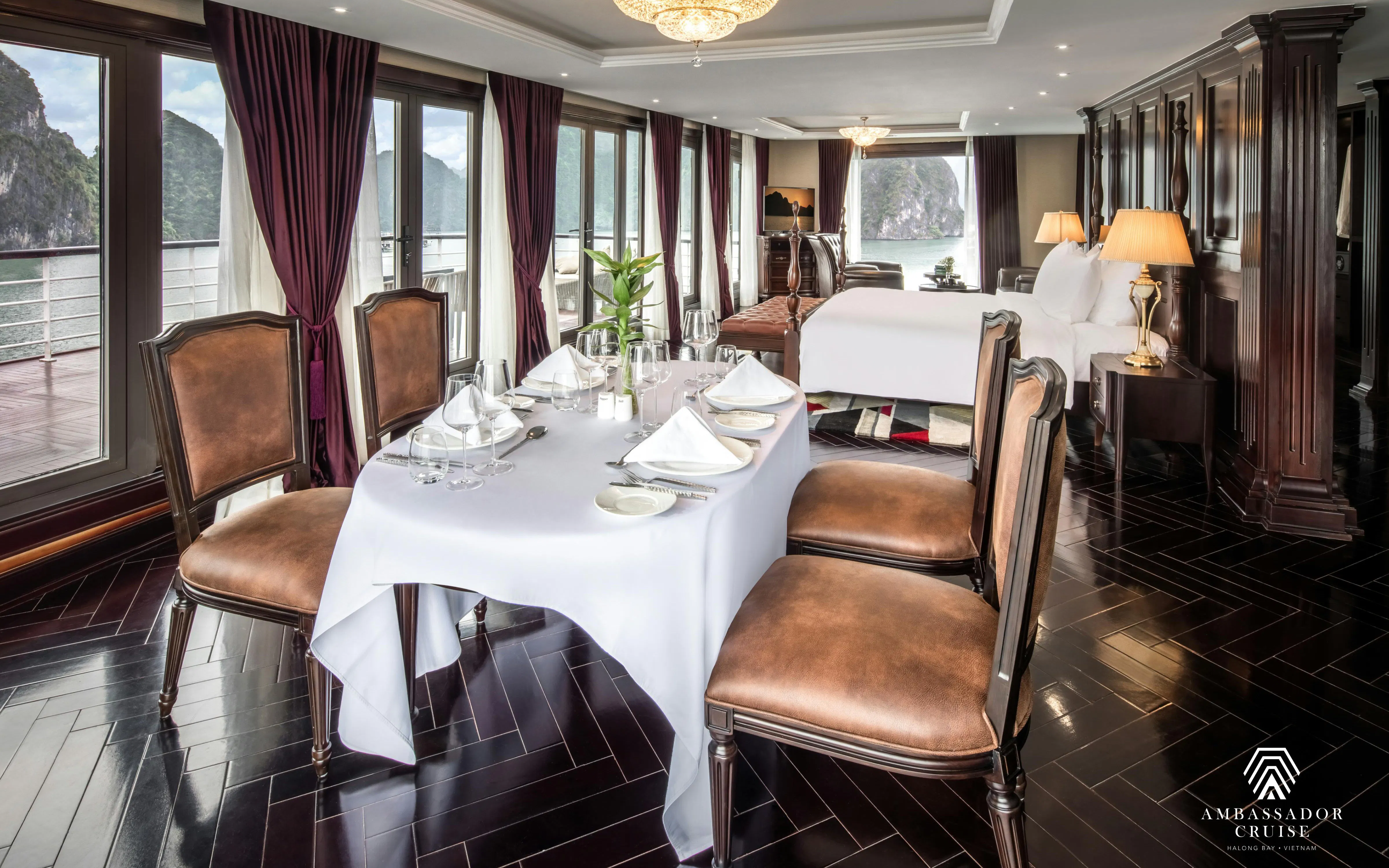 Luxury suite interior on Ha Long Bay 5-star Ambassador Cruise with dining table and bay view.