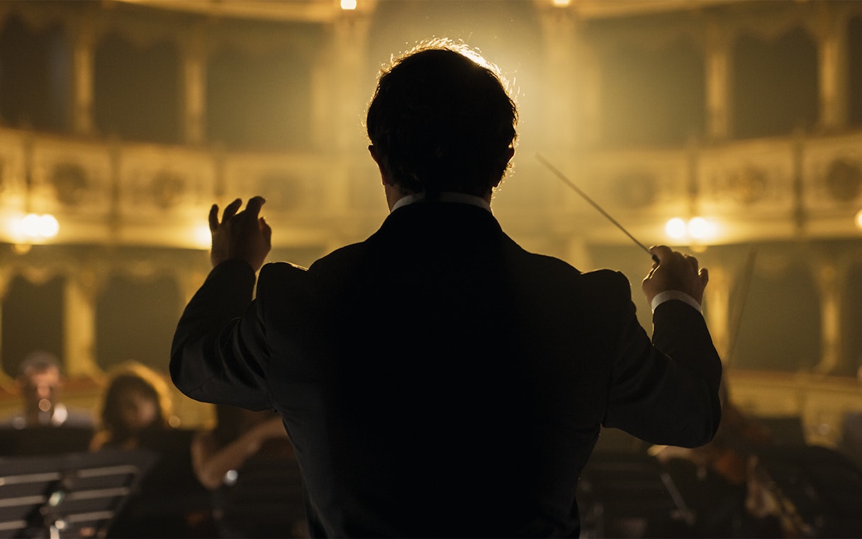 Conductor leading orchestra at Classic Ensemble Vienna Concert, St. Peter's Church.