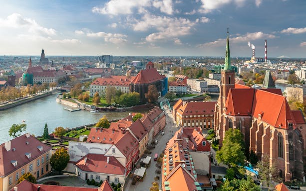 Aerial view of Wroclaw cityscape from Cathedral Tower, showcasing historic architecture and vibrant streets.