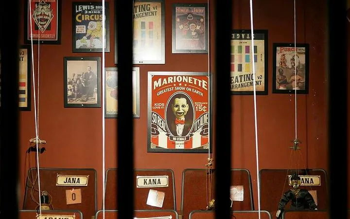 Marionette posters and strings in an escape room setting, Breakout NU Sentral, Dubai.