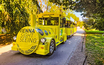 Yellow panoramic sightseeing train at Schonbrunn Palace, Vienna.