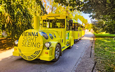 Yellow panoramic sightseeing train at Schonbrunn Palace, Vienna.