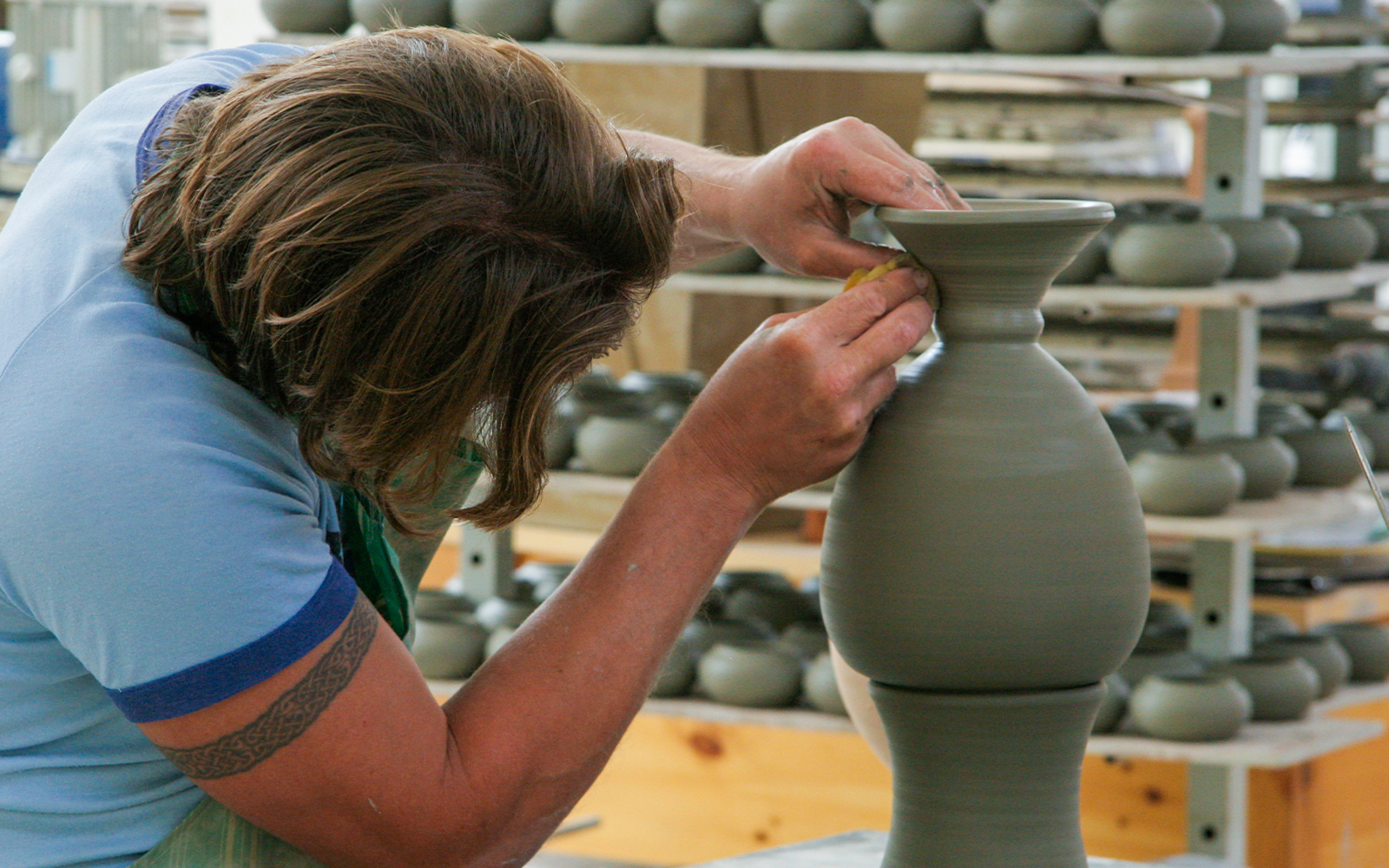 Potter shaping clay vase in Mdina workshop, Malta tour.