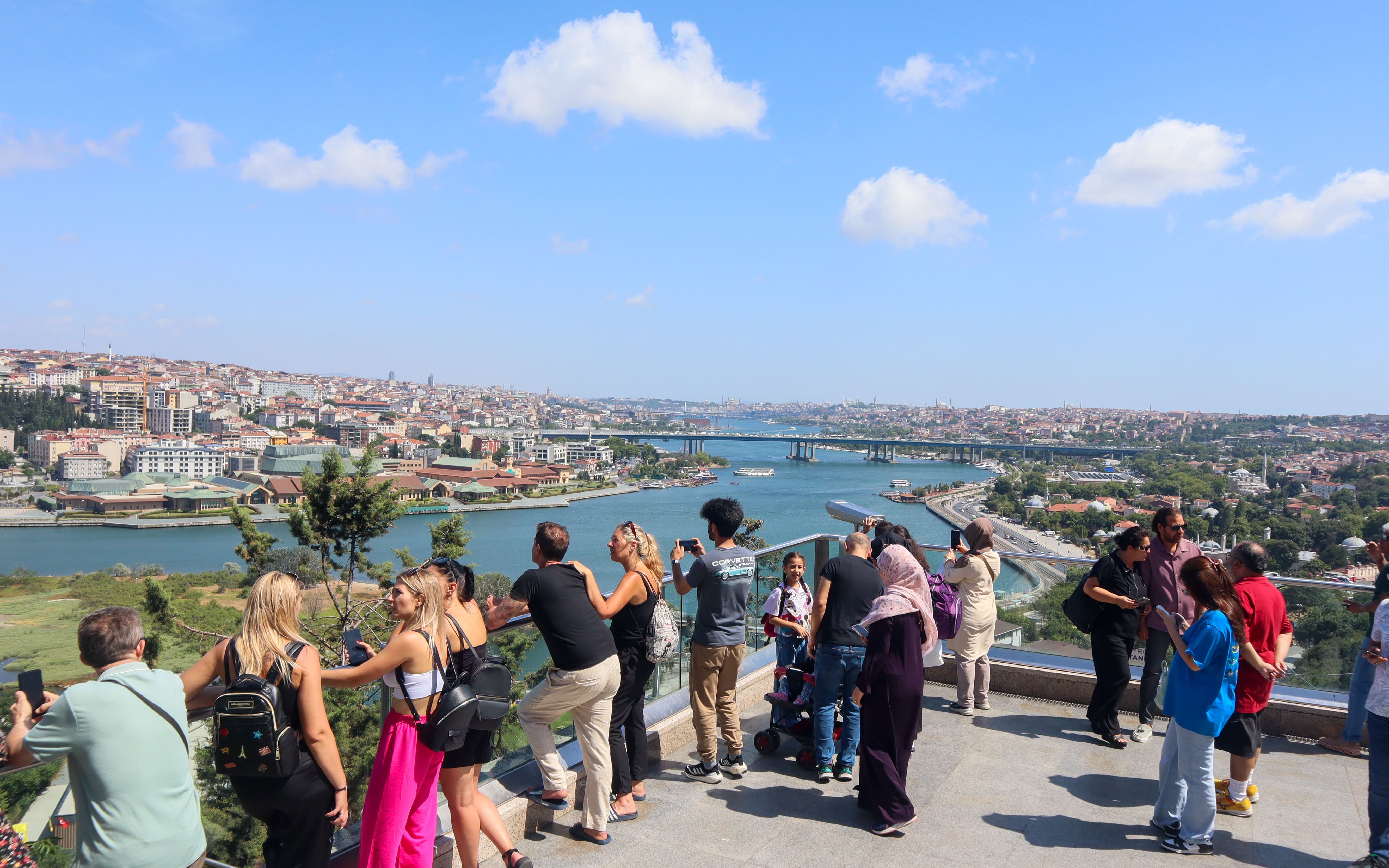 Tourists enjoying the view of Istanbul from Pierre Loti Hill, overlooking the Golden Horn.