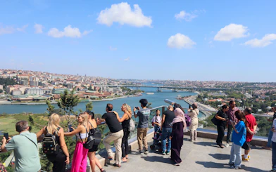 Tourists enjoying the view of Istanbul from Pierre Loti Hill, overlooking the Golden Horn.