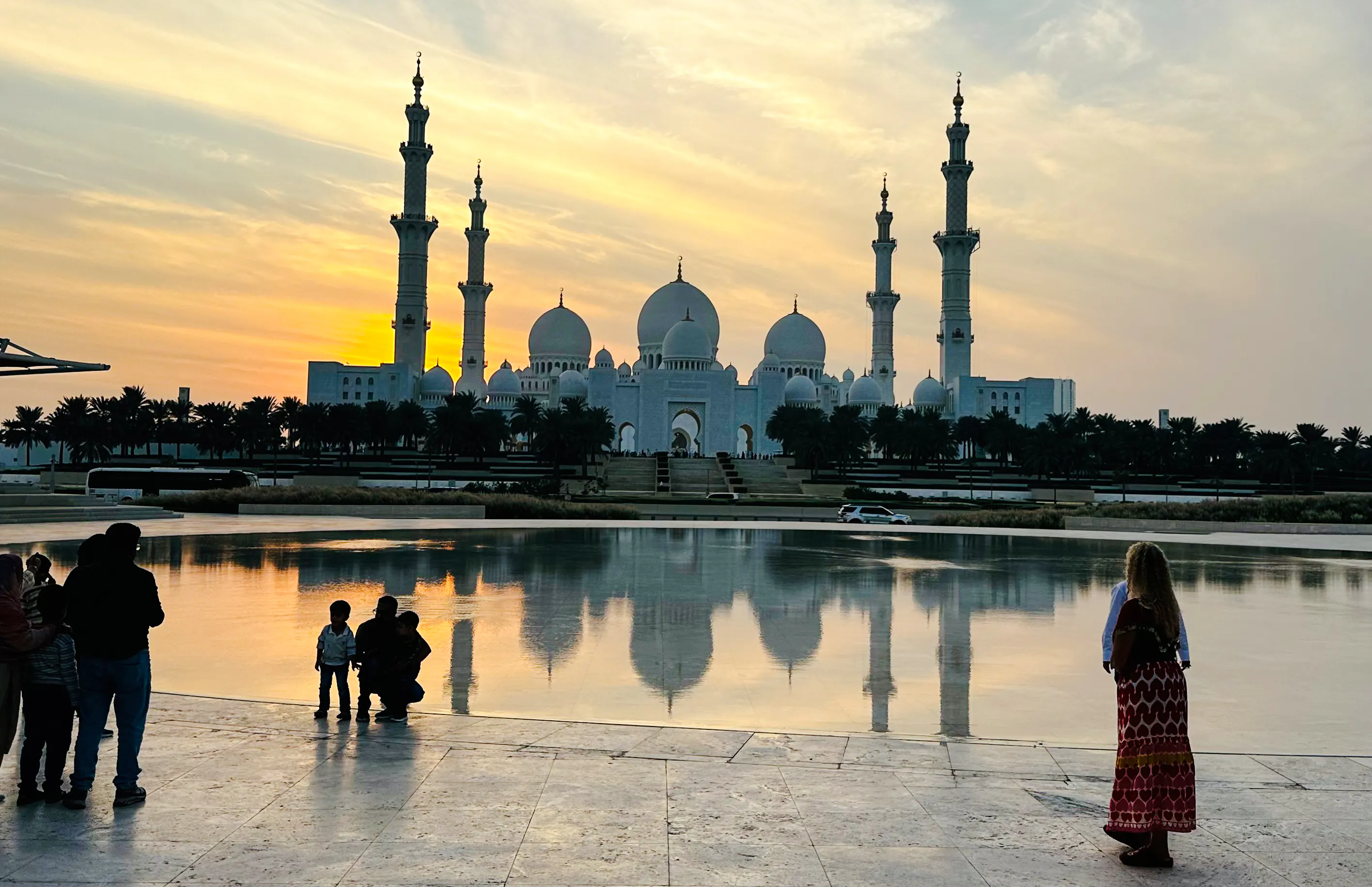 Sheikh Zayed Grand Mosque at sunset with reflection in water, Abu Dhabi.