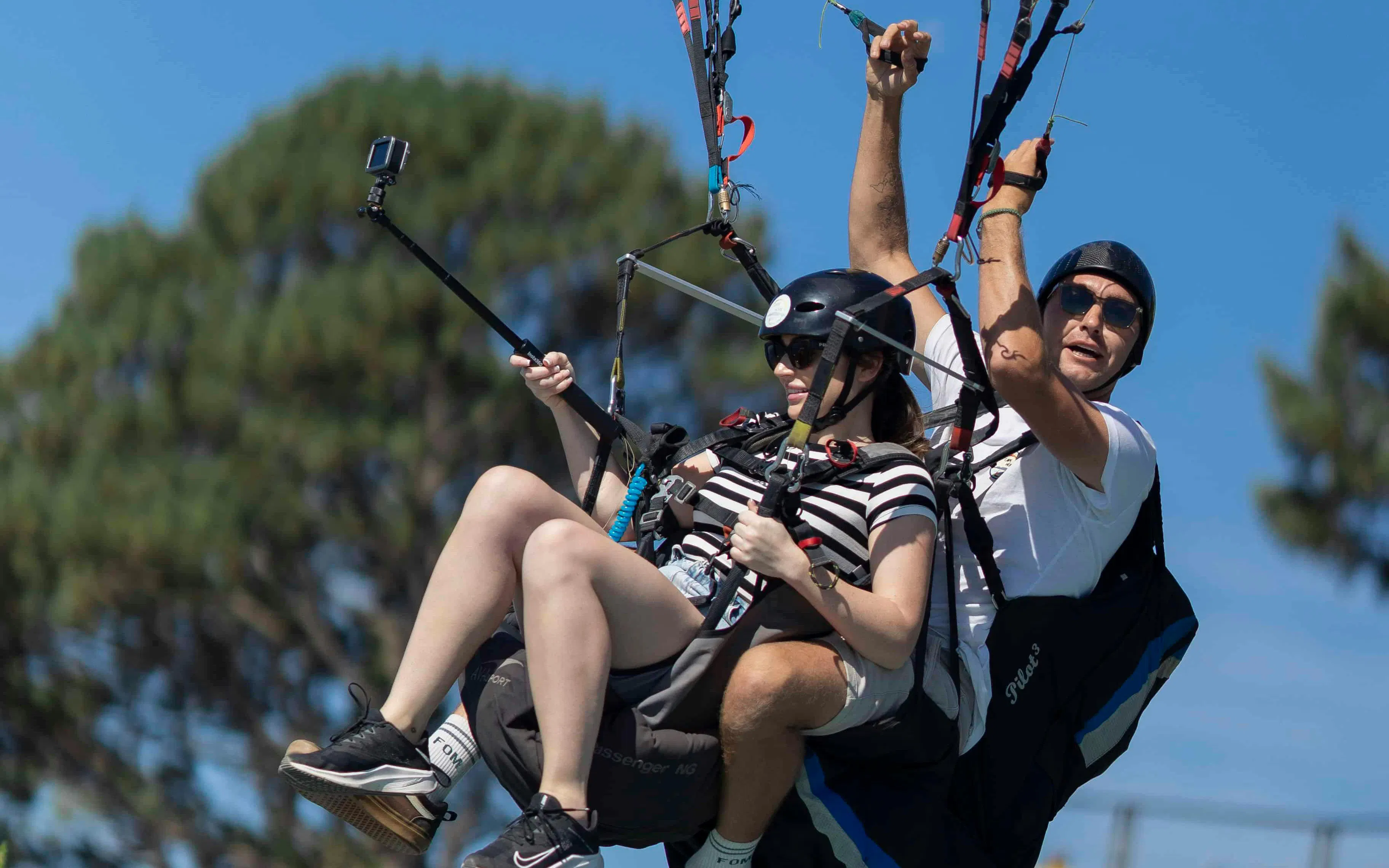 Tandem paragliding over Cape Town with a guide and guest capturing the experience.
