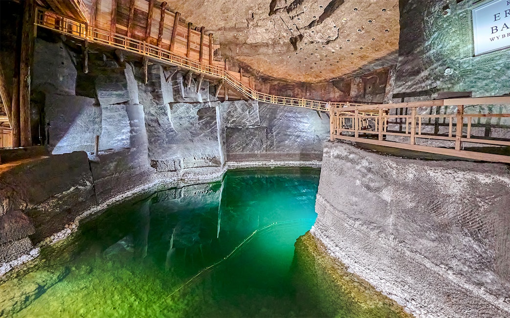 Underground lake with wooden walkways in Wieliczka Salt Mine, Poland.
